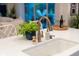 Kitchen island featuring a stainless steel faucet, quartz countertop, and a deep sink at 2586 Wild Cherry Path, Sarasota, FL 34240
