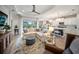 Open-concept living room flows into the kitchen with large windows overlooking the backyard and pool at 2586 Wild Cherry Path, Sarasota, FL 34240