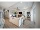 Spacious living room with tray ceiling, modern decor, and views of the backyard through sliding glass doors at 2586 Wild Cherry Path, Sarasota, FL 34240