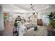 Bright open-concept living area featuring hardwood floors and seamlessly flowing into the modern kitchen at 2586 Wild Cherry Path, Sarasota, FL 34240
