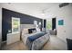 Beautiful bedroom suite with a plush upholstered bed, soft lighting, and stylish decor at 2586 Wild Cherry Path, Sarasota, FL 34240