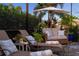Cozy screened-in patio with comfortable outdoor seating and lush greenery at 2586 Wild Cherry Path, Sarasota, FL 34240