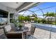 Screened-in patio with outdoor dining and seating area and a spa at 2586 Wild Cherry Path, Sarasota, FL 34240