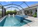 Inviting screened-in pool with a raised spa and sun loungers at 2586 Wild Cherry Path, Sarasota, FL 34240