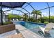 Relaxing screened-in pool area with a spa, pool, and lounge seating at 2586 Wild Cherry Path, Sarasota, FL 34240