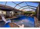 The screened-in pool area has a jacuzzi, an outdoor kitchen, and lots of room to relax at 2586 Wild Cherry Path, Sarasota, FL 34240