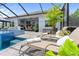 Stunning pool with spa, sun loungers, outdoor kitchen, and dining area at 2586 Wild Cherry Path, Sarasota, FL 34240