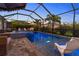 Beautiful pool and spa with blue lighting and poolside seating at dusk at 2586 Wild Cherry Path, Sarasota, FL 34240