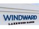 Windward Lakewood Ranch community sign with blue lettering on white wall at 2586 Wild Cherry Path, Sarasota, FL 34240