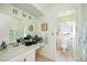 Bright bathroom featuring a vanity with sink, a large mirror, and a separated toilet at 307 Rubens Dr, Nokomis, FL 34275