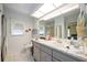 Well-lit bathroom with a vanity, sink, and a large mirror above the sink at 307 Rubens Dr, Nokomis, FL 34275