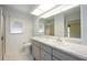 Bright bathroom featuring a large mirror, updated vanity, and a walk-in shower at 307 Rubens Dr, Nokomis, FL 34275