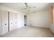 Bedroom with white walls and carpeting, a ceiling fan, and a closet with louvered doors at 307 Rubens Dr, Nokomis, FL 34275