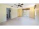 Bedroom with a ceiling fan, a closet with mirror doors and light-colored walls and carpeting at 307 Rubens Dr, Nokomis, FL 34275