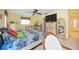 Bright bedroom with coordinated furnishings and a comfortable sitting area at 307 Rubens Dr, Nokomis, FL 34275