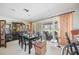 Well-lit dining area that opens to the screened patio for seamless indoor-outdoor living at 307 Rubens Dr, Nokomis, FL 34275