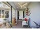 Charming entry area with covered ceiling, potted plants, decorative accessories and bench at 307 Rubens Dr, Nokomis, FL 34275