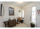 Inviting entryway with a charming dresser, unique decor, and ample natural light at 307 Rubens Dr, Nokomis, FL 34275
