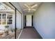 Inviting covered entryway with a ceiling fan and courtyard view at 307 Rubens Dr, Nokomis, FL 34275
