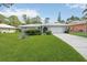 Charming single-story home featuring a well-manicured lawn and a white tiled roof at 307 Rubens Dr, Nokomis, FL 34275