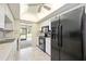 Eat-in kitchen with black appliances and screened-in back porch access at 307 Rubens Dr, Nokomis, FL 34275