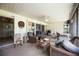 Covered lanai includes ceiling fan, comfortable outdoor seating, and views to backyard at 307 Rubens Dr, Nokomis, FL 34275