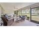 Relaxing screened lanai with comfortable seating, ceiling fan, and views of the backyard at 307 Rubens Dr, Nokomis, FL 34275