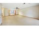 Expansive open-concept living area with large window, ceiling fan and access to other parts of the house at 307 Rubens Dr, Nokomis, FL 34275
