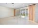 Open living room with sliding glass doors to backyard patio offers natural light at 307 Rubens Dr, Nokomis, FL 34275