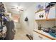 Functional utility room featuring storage cabinets and a water heater at 307 Rubens Dr, Nokomis, FL 34275