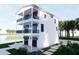 Stunning exterior featuring three floors, multiple balconies, and large, black-framed windows at 312 Avenida Leona, Sarasota, FL 34242
