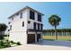 Modern three-story home with sleek lines, a two-car garage and lush landscaping at 312 Avenida Leona, Sarasota, FL 34242