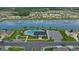 This captivating aerial view showcases a community pool, lake with fountains, and surrounding homes, perfect for recreation and relaxation at 3813 Willow Branch Pl, Palmetto, FL 34221
