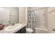 Bathroom with a shower-tub combination, and a gray vanity with a decorative sink at 3813 Willow Branch Pl, Palmetto, FL 34221