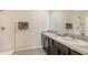 Bright bathroom featuring double sinks, large mirror, and a shower at 3813 Willow Branch Pl, Palmetto, FL 34221