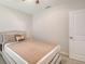 Comfortable bedroom featuring neutral tones and a decorative headboard with matching linens at 3813 Willow Branch Pl, Palmetto, FL 34221