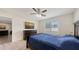 This bedroom features a ceiling fan, carpeted floors, and a window providing natural light at 3813 Willow Branch Pl, Palmetto, FL 34221