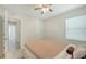 Bedroom features a ceiling fan and natural light from a window at 3813 Willow Branch Pl, Palmetto, FL 34221