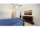 Bedroom boasts ceiling fan, dresser with TV, and an open doorway at 3813 Willow Branch Pl, Palmetto, FL 34221