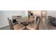Dining area with a round wooden table, four chairs, and ample natural light at 3813 Willow Branch Pl, Palmetto, FL 34221