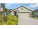Charming one-story home with a two-car garage, front yard landscaping, and a welcoming entrance at 3813 Willow Branch Pl, Palmetto, FL 34221