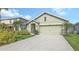 Charming one-story home with a two-car garage, front yard landscaping, and a welcoming entrance at 3813 Willow Branch Pl, Palmetto, FL 34221