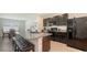Modern kitchen featuring granite countertops, stainless steel appliances, and dark wood cabinets at 3813 Willow Branch Pl, Palmetto, FL 34221