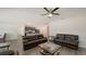Spacious living room that flows into the kitchen, featuring hardwood floors and a ceiling fan at 3813 Willow Branch Pl, Palmetto, FL 34221