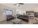 Open-concept living room with hardwood floors, connecting seamlessly to the dining and kitchen areas at 3813 Willow Branch Pl, Palmetto, FL 34221