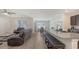 Spacious living room area with barstool seating at the kitchen, perfect for modern living and entertaining at 3813 Willow Branch Pl, Palmetto, FL 34221