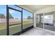 Spacious screened porch providing views of the backyard with lush green grass and a privacy fence at 3813 Willow Branch Pl, Palmetto, FL 34221