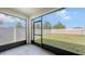 Spacious screened porch overlooking a fenced backyard with lush green grass and trees at 3813 Willow Branch Pl, Palmetto, FL 34221