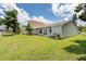 Spacious backyard featuring lush green grass and a view of the home's exterior at 4214 38Th W St, Bradenton, FL 34205
