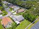 Aerial view of backyard featuring green lawn, mature trees, white fencing, and a cozy covered patio at 4214 38Th W St, Bradenton, FL 34205